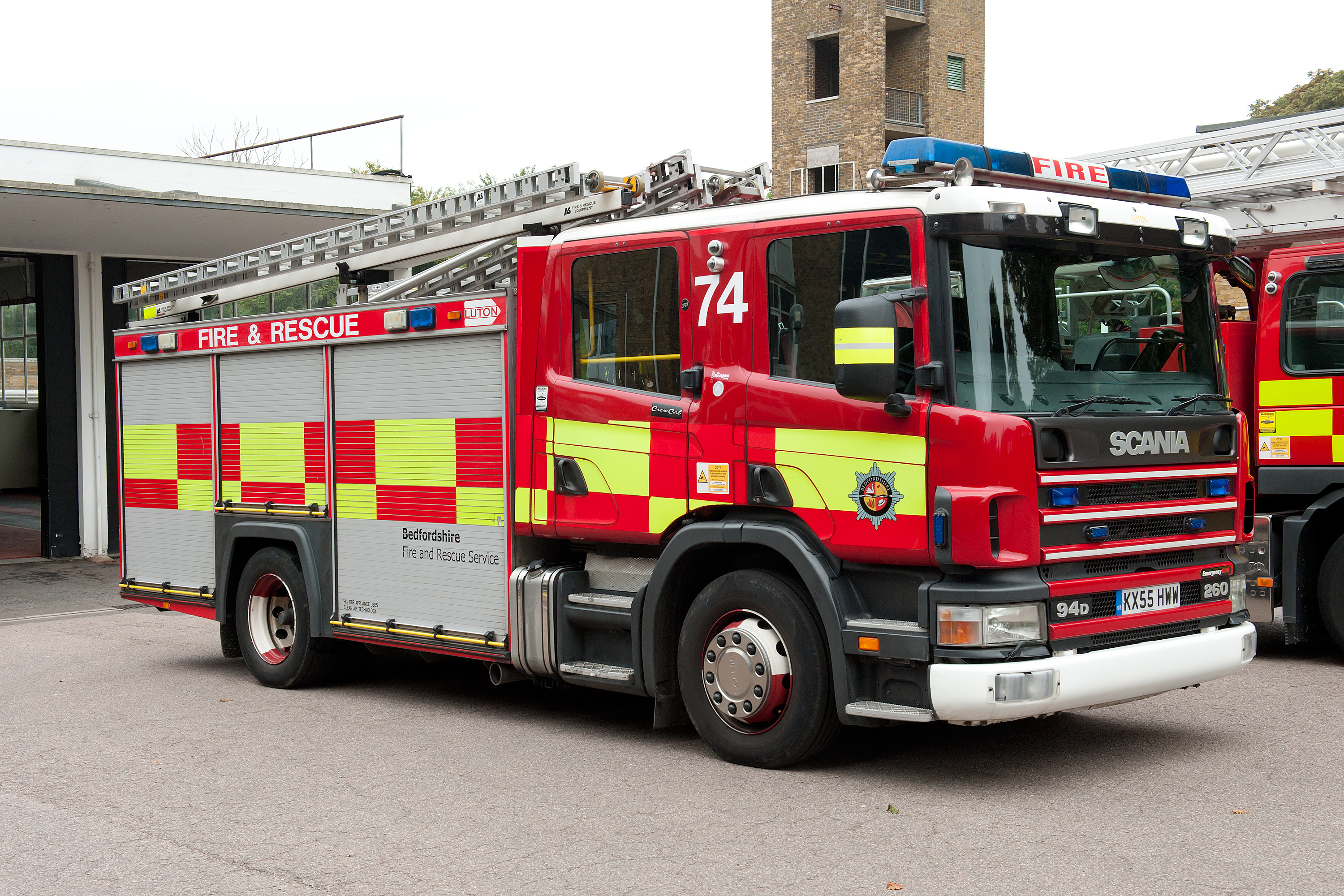 Photo of a fire engine parked outside a fire station