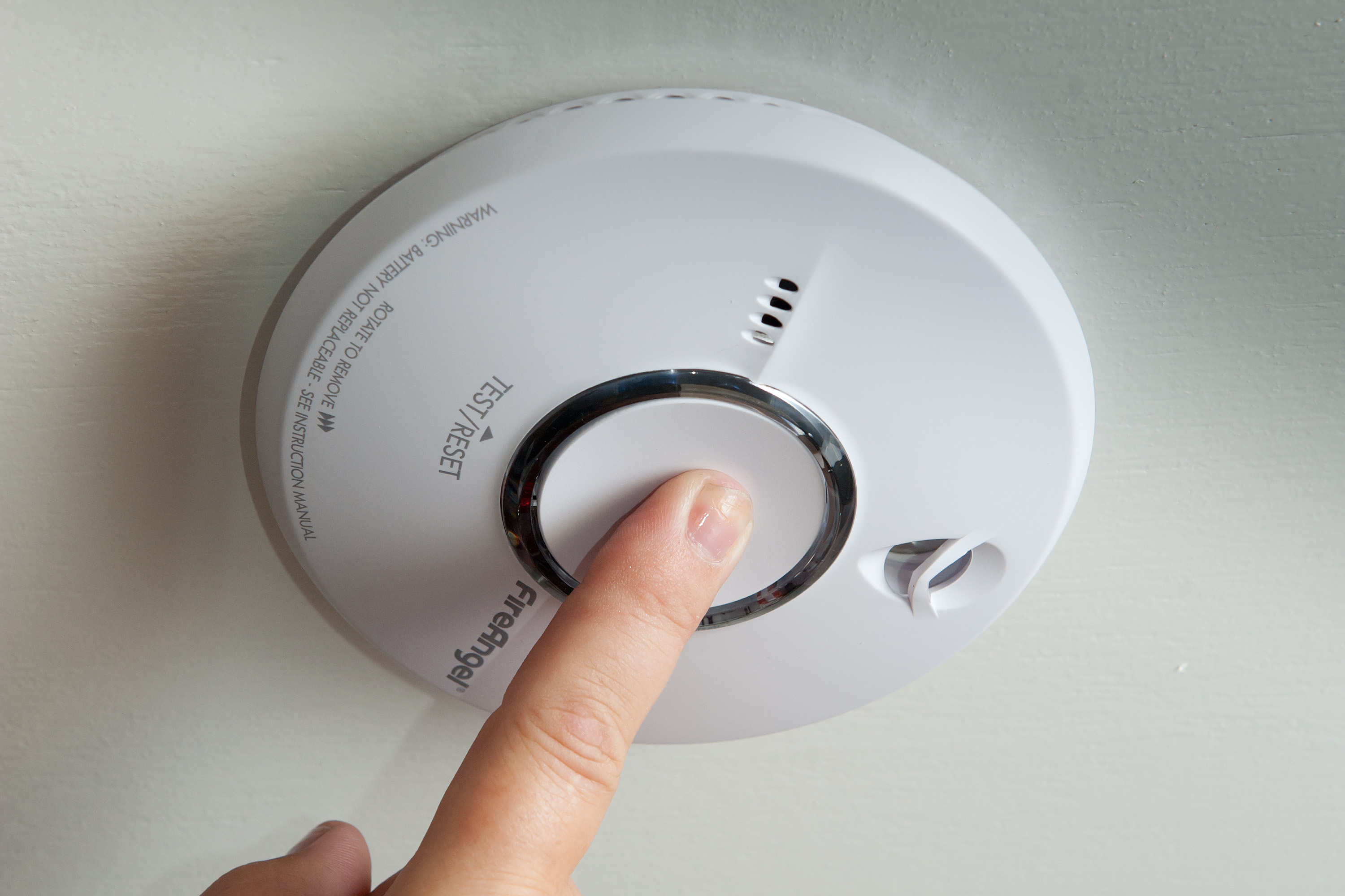 A picture of a smoke alarm that is being tested