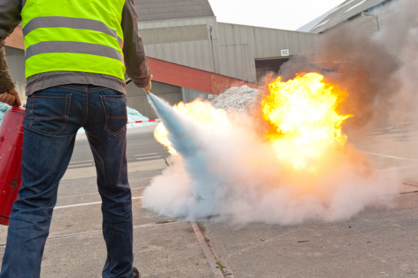 Man operating fire extinguisher