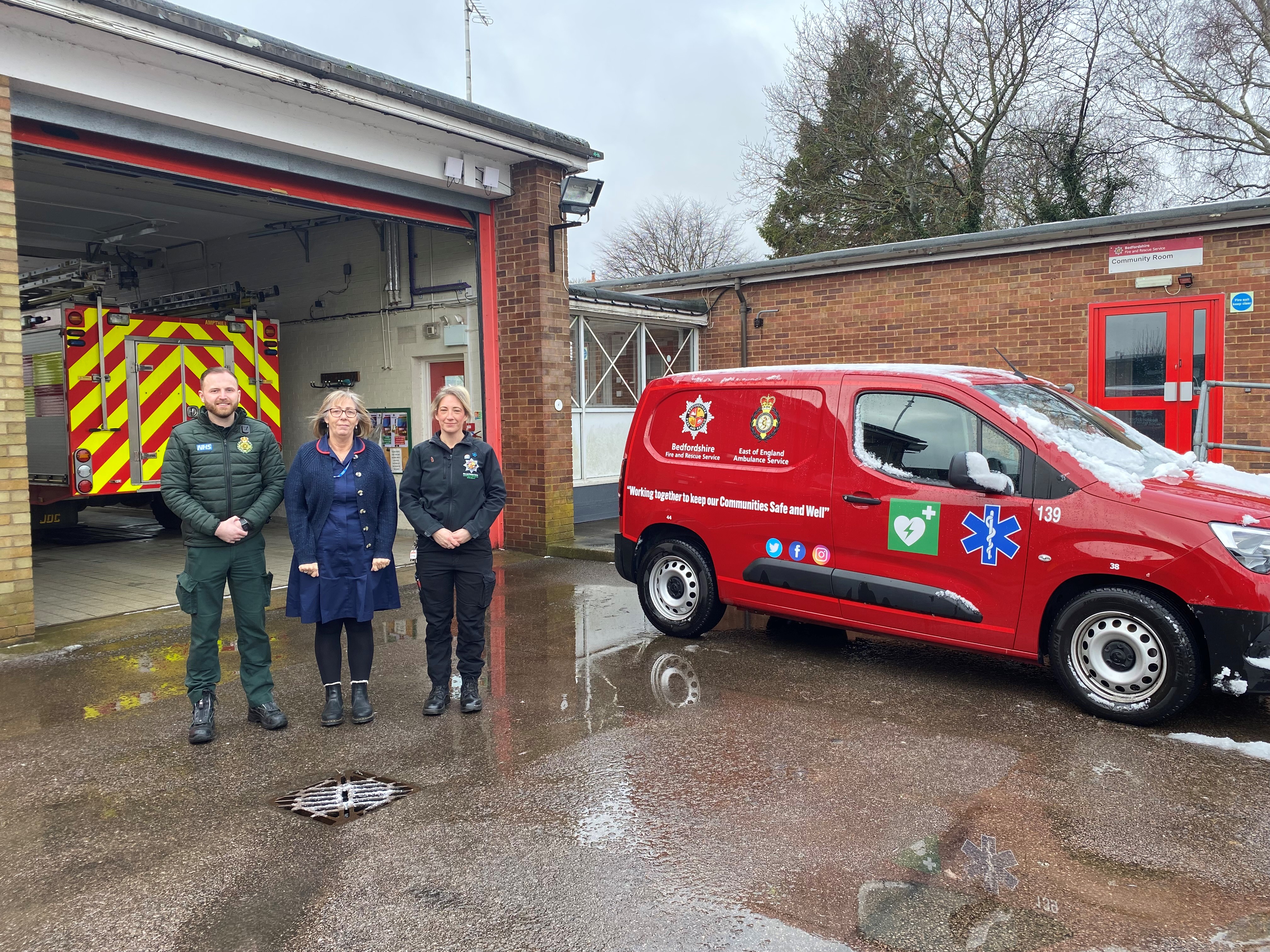 Members of the falls team next to the falls response vehicle