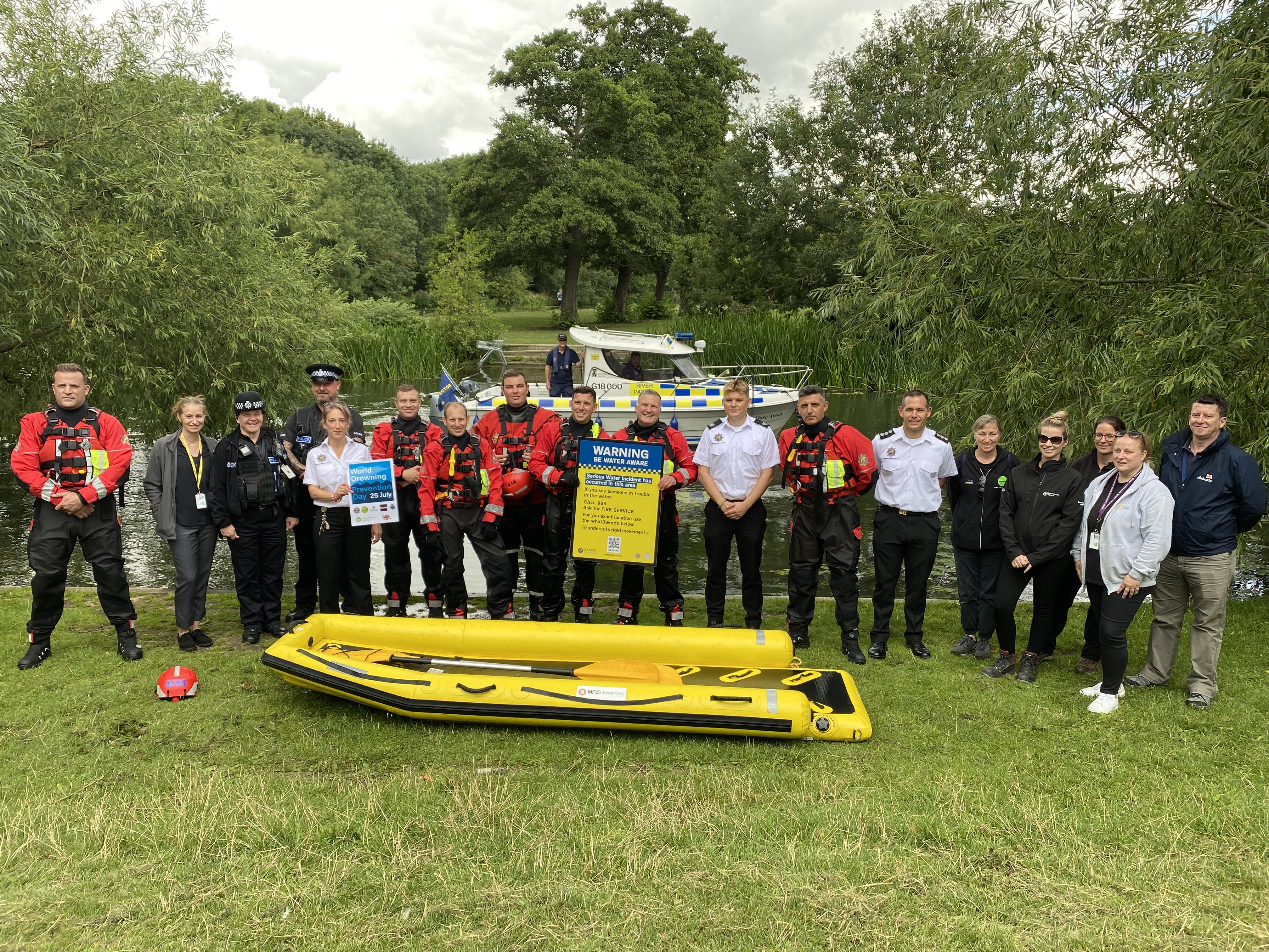 Bedfordshire Fire and Rescue Service personnel alongside agency colleagues holding up new water safety signage 