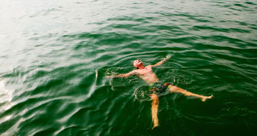 man floating in water