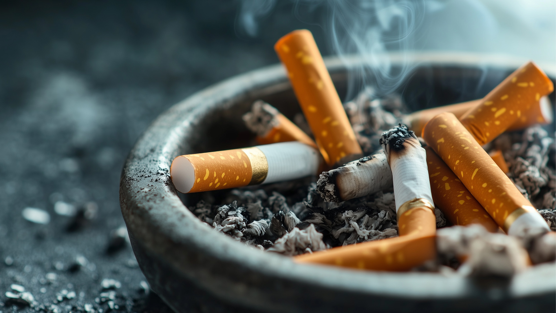 An ashtray with smoke rising from a discarded cigarette.