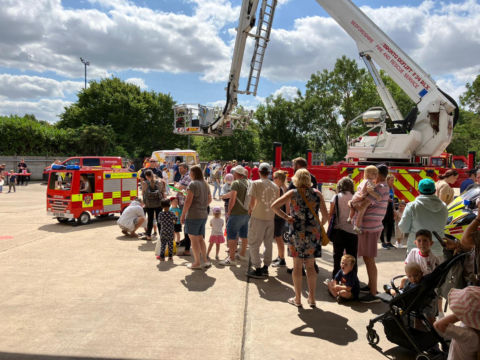An image of a crowd near to a fire engine