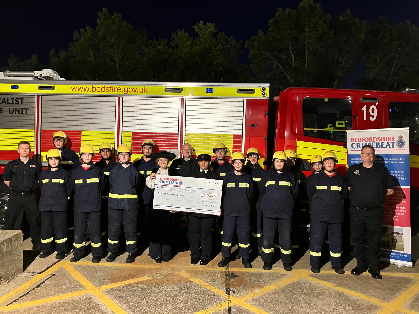 Fire Cadets and High Sheriff of Bedfordshire, Camilla King, in front of a fire engine