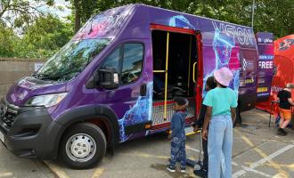 Children queuing by the Virtual Reality van