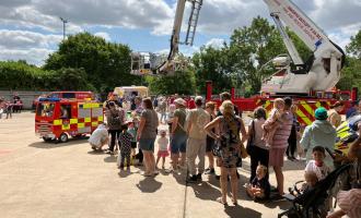 Queue of people by a fire engine