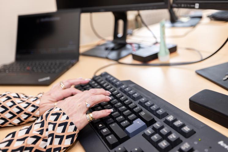 Hands typing on a keyboard