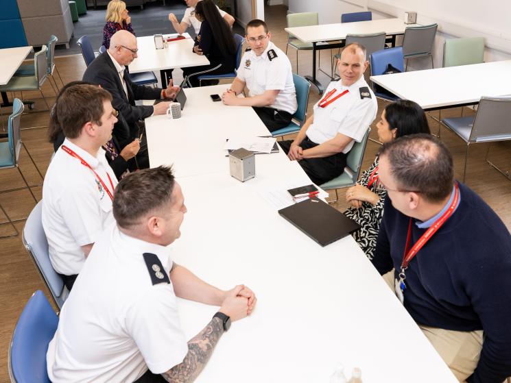BFRS colleagues sitting at a white table