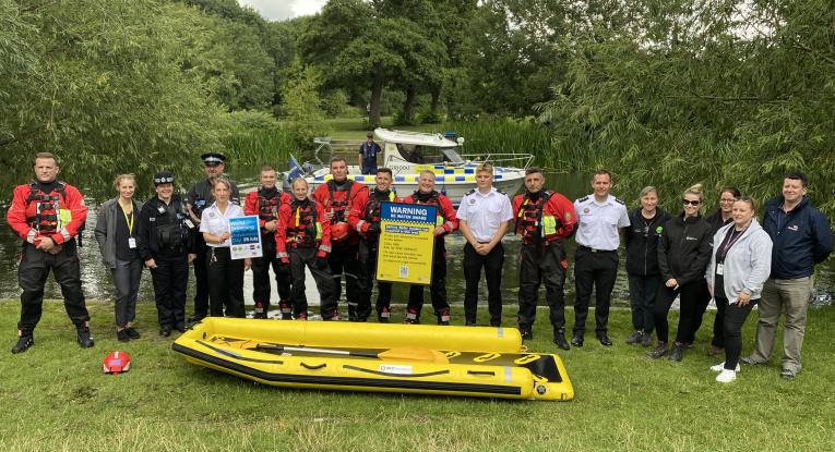 Bedfordshire Fire and Rescue Service personnel alongside agency colleagues holding up new water safety signage 