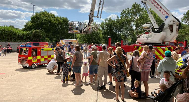 An image of a crowd near to a fire engine